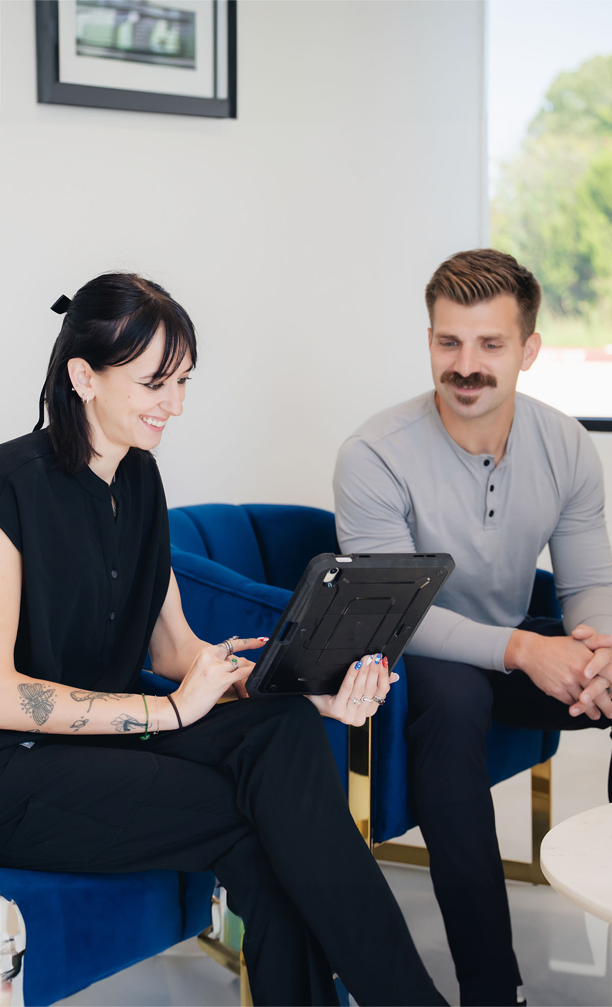 Receptionist helps a patient with a tablet